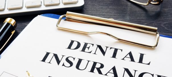 dental insurance on clipboard for dentist in los angeles