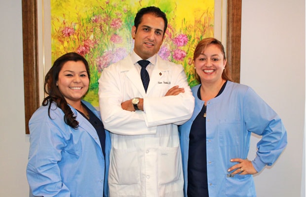 Dr. Alan Zabolian with staff on his left and right picture