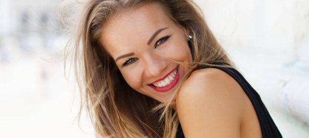 Side angle smiling woman windswept hair